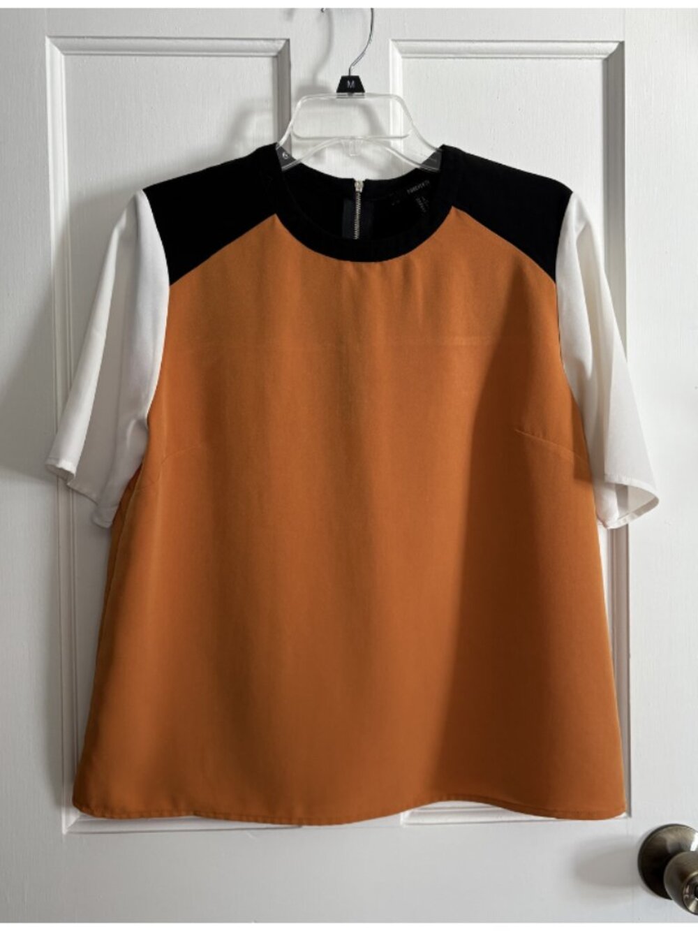 Gold, black, and white color block top